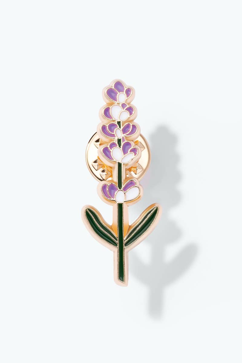 Floral brooch with purple flowers and green leaves on a white background