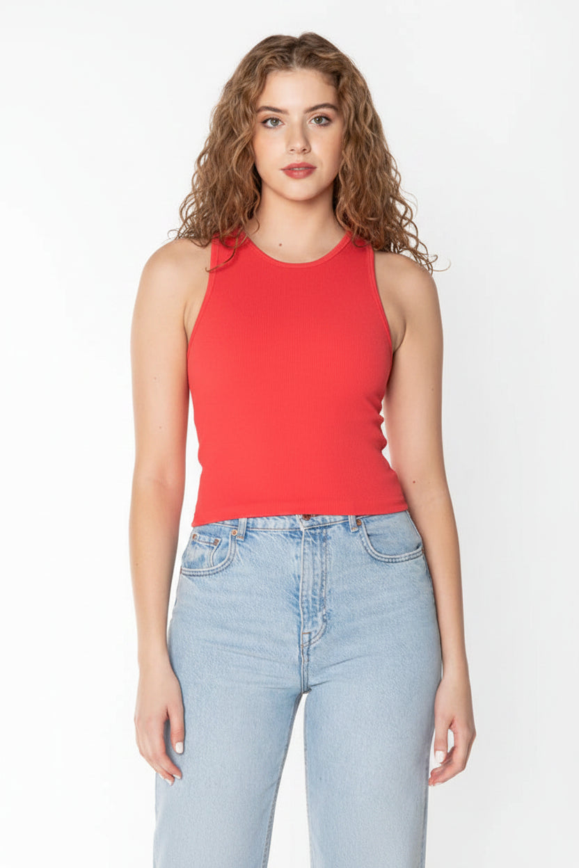Woman wearing a red sleeveless top and light blue jeans on a white background