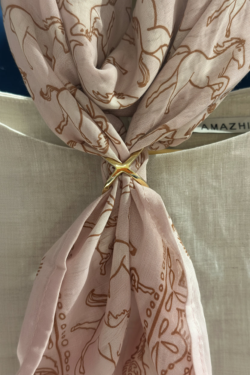 Neatly tied beige scarf with horse pattern on a neutral background