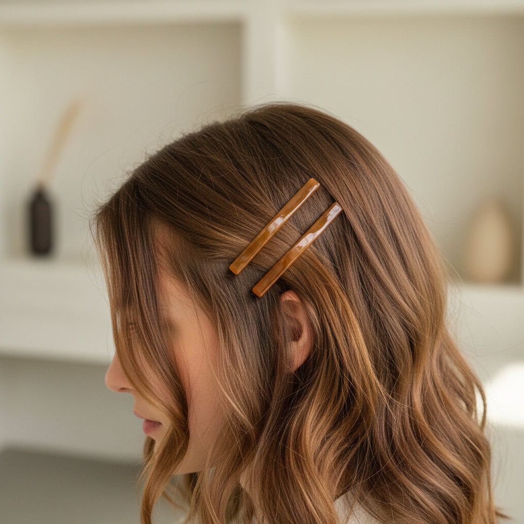 Two brown hair clips on a white background