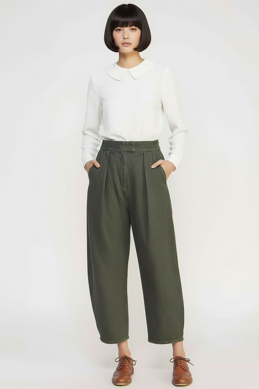 Person wearing a white shirt and green pants on a white background