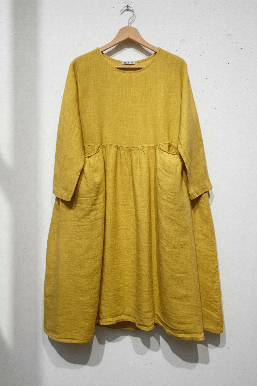 Yellow dress with long sleeves and pockets on a white background